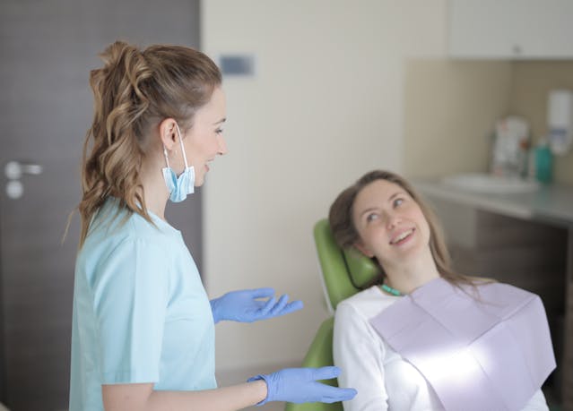 dentist talking to patient about referring her to a specialist