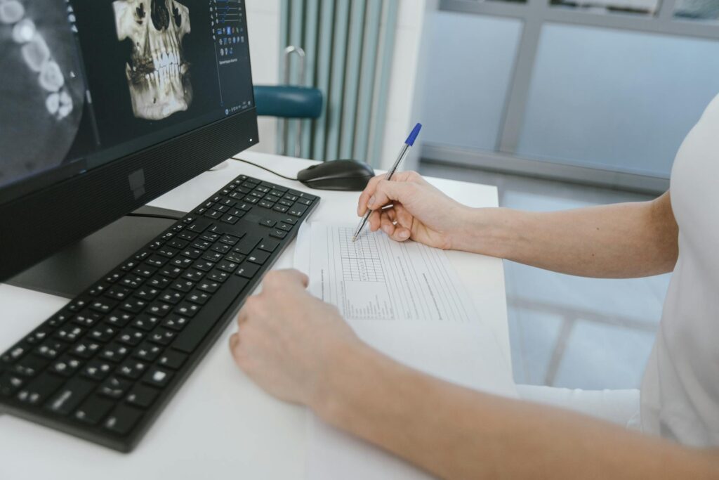 dentist writing treatment letters to each patient