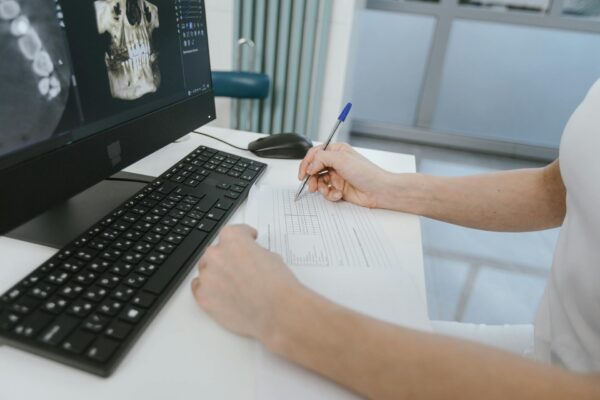 dentist writing treatment letters to each patient